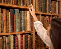female-choosing-book-from-bookshelf-library_23-2148204317